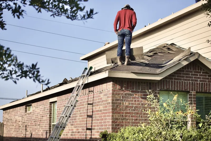 Professional roofer working on a residential roof in Garfield Park
